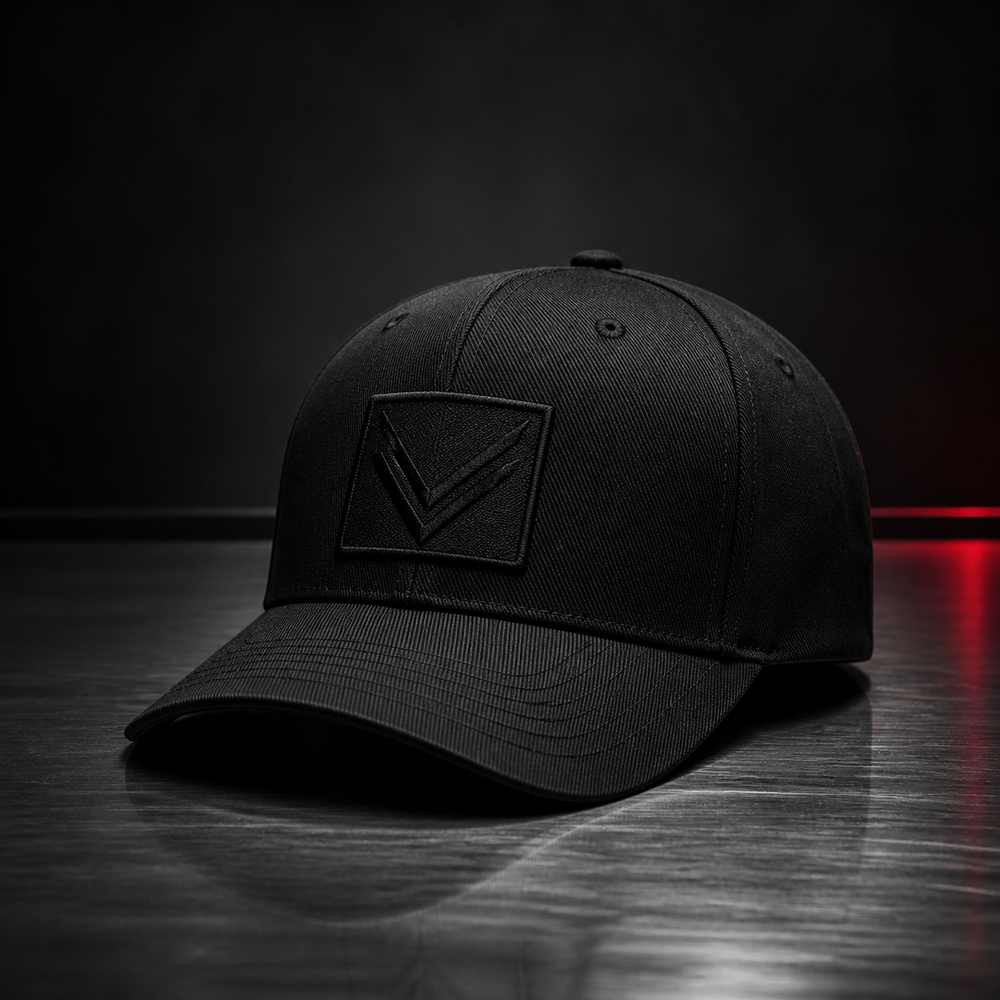 Vortray Black Patch Cap on a dark steel surface