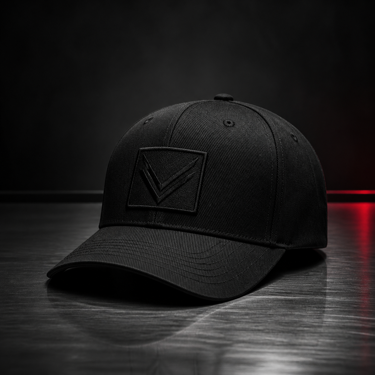Vortray Black Patch Cap on a dark steel surface